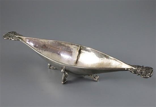A George V Arts and Crafts Omar Ramsden planished silver two handled boat shaped dish, 9.5oz.